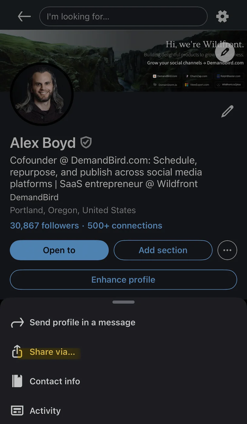 LinkedIn mobile profile with three-dot menu open, showing Send profile in a message and Share via options